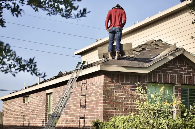 Professional roofer working on a residential roof in Embassy Hills